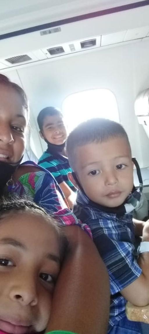 Calcurian and her three kids on the flight from Boa Vista, in the north of Brazil, to São Paulo in October of 2021.