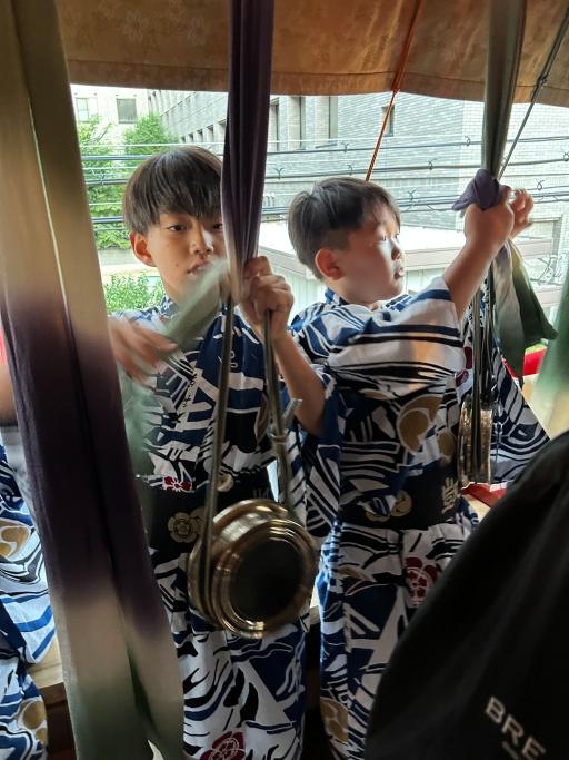 Two boys take part in creating Gion Bayashi music.