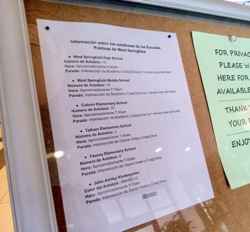 Two papers stapled to a board filled with text