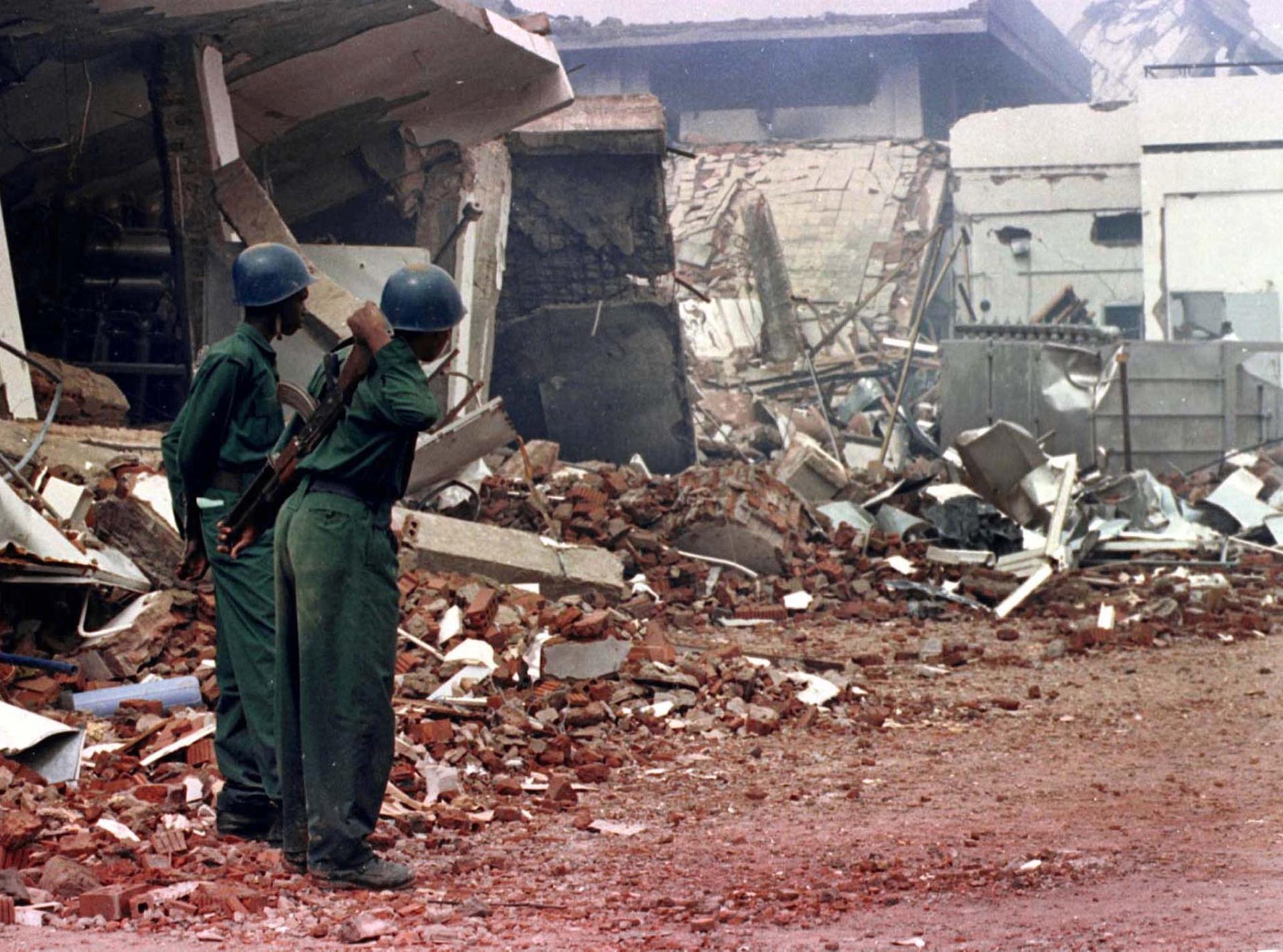 Sudanese security forces stand guard by the flattened rubble of a pharmaceutical factory in the northern outskirts of Khartoum, on Aug. 22, 1998. The United States attacked the plant on Aug. 20, saying it was involved in chemical weapons production and ha