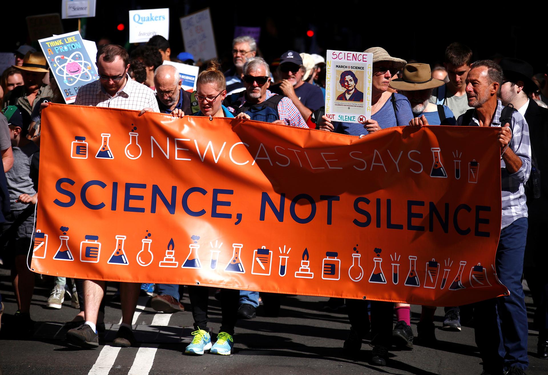 Protesters hold placards and banners as they participate in the March for Science rally on Earth Day, in central Sydney, Australia April 22, 2017.