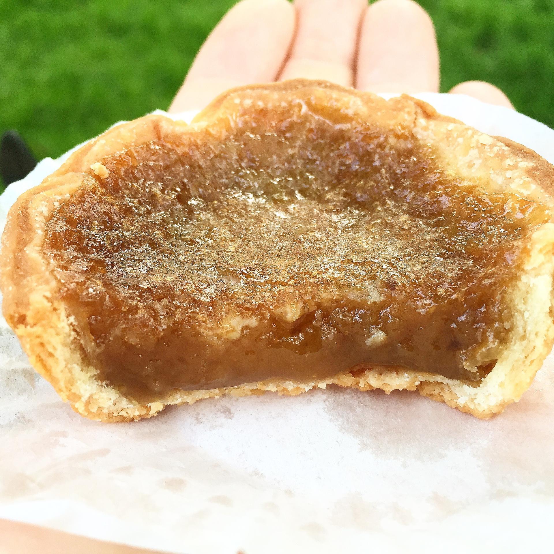 Yummy, intensely sweet, half eaten Butter Tart fits into your hand.
