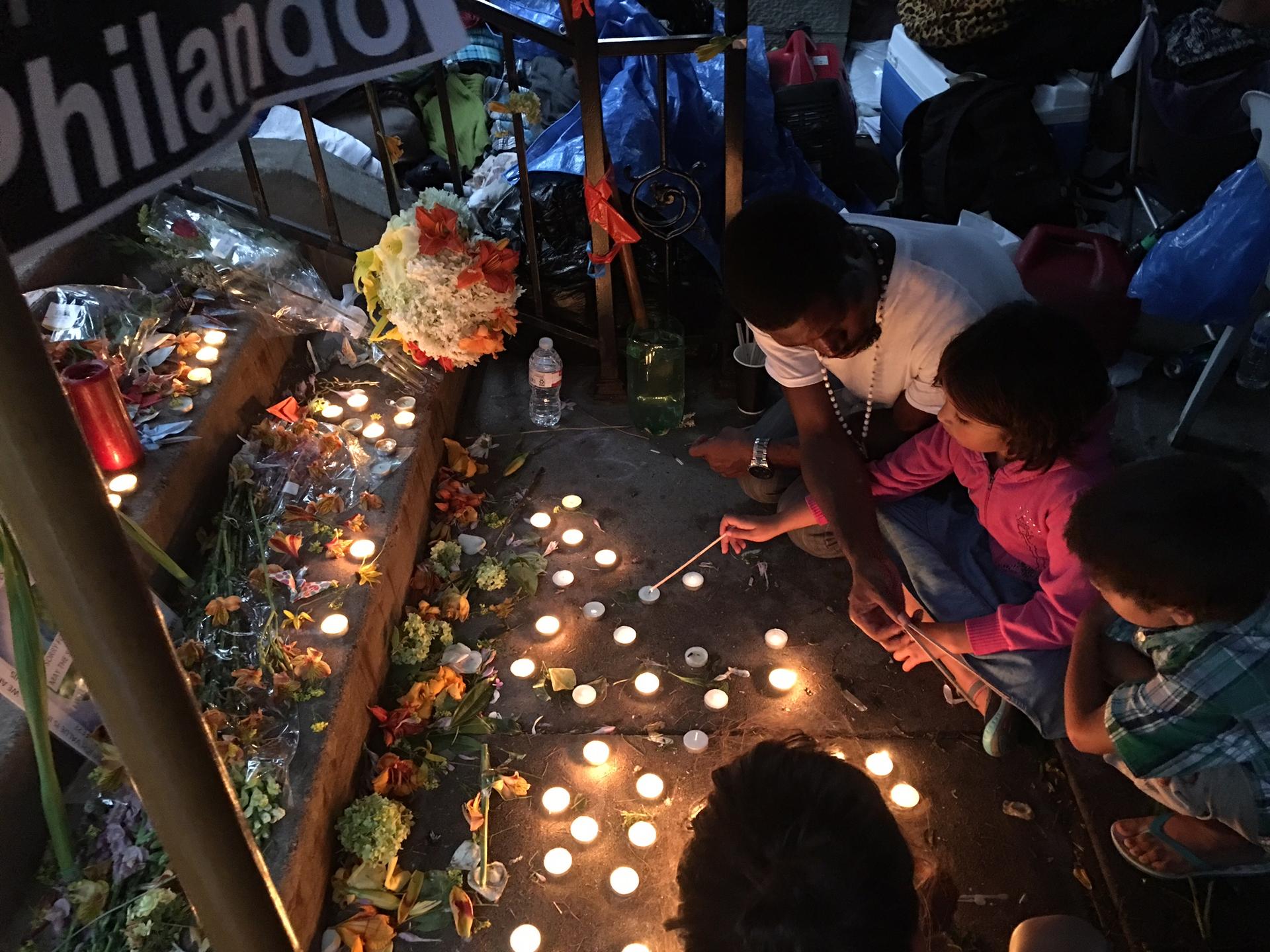 People light candles on the ground