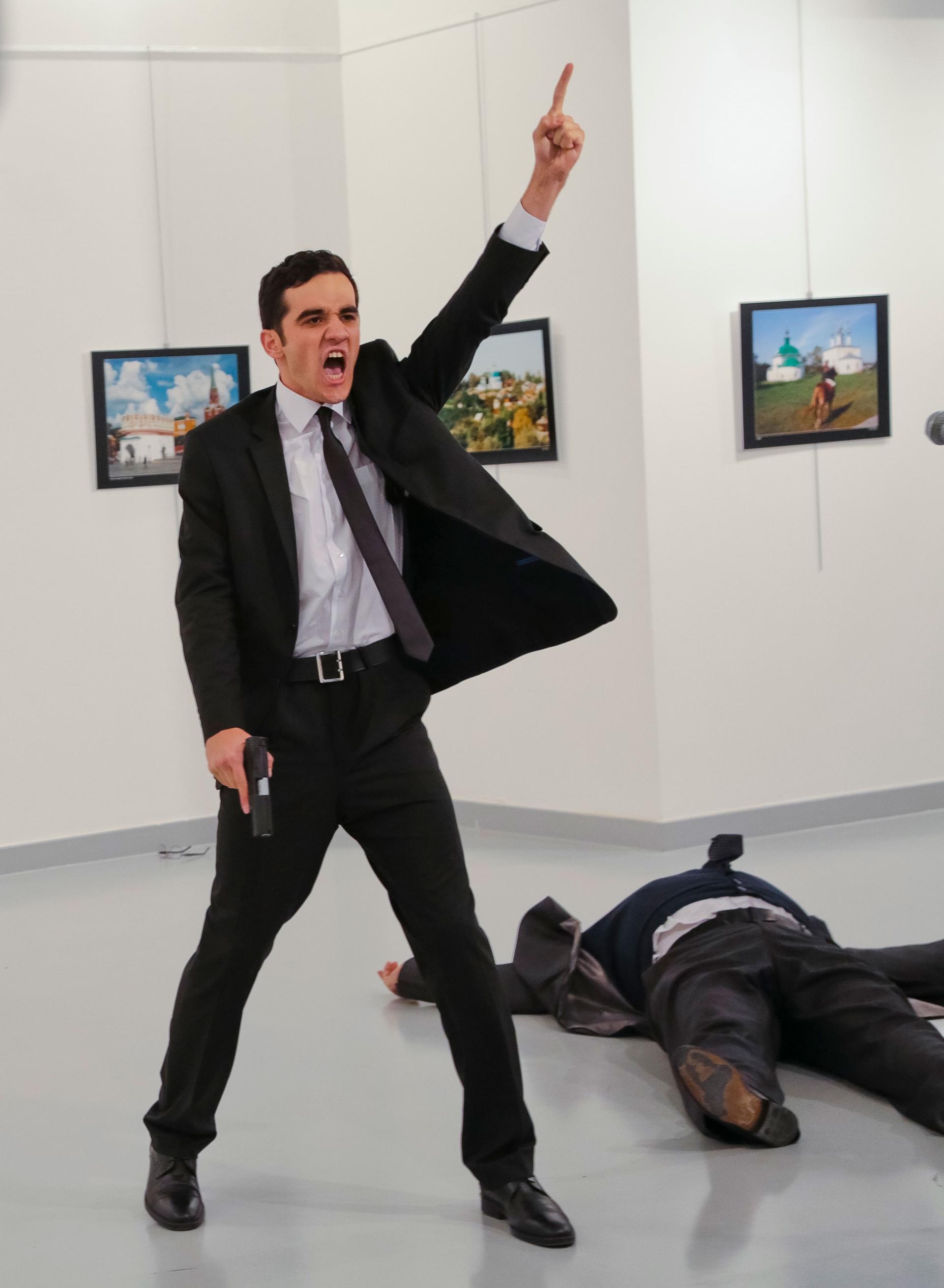 An unnamed gunman gestures after shooting the Russian Ambassador to Turkey, Andrei Karlov.