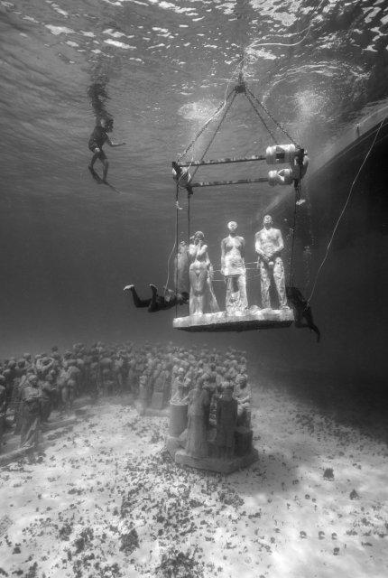 A sculpture is lowered into place on the ocean floor Jason deCaires Taylor
