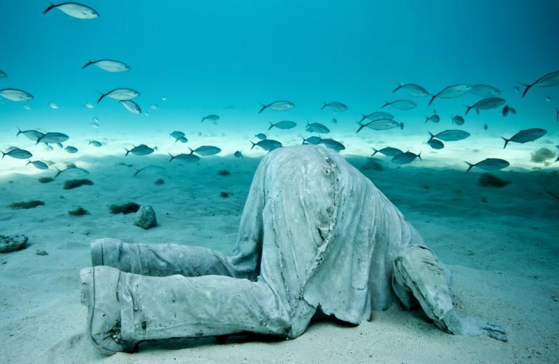 'The Banker' is part of the MUSA Collection and one of a series of sculptures off the coast of Cancun and Isla Mujeres, Mexico