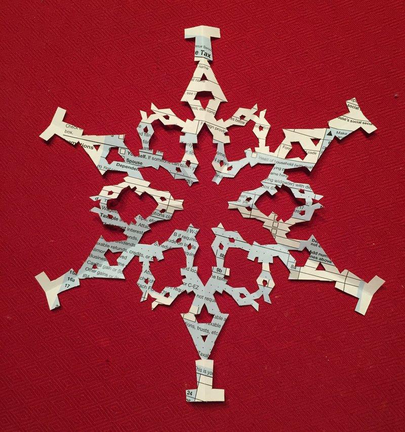 From Les Barker: 'My creative outlet is intricate paper snowflakes. I quickly tried my hand at sketching the work 'TAX' a couple times on my paper and then cutting them out with an X-acto knife.'