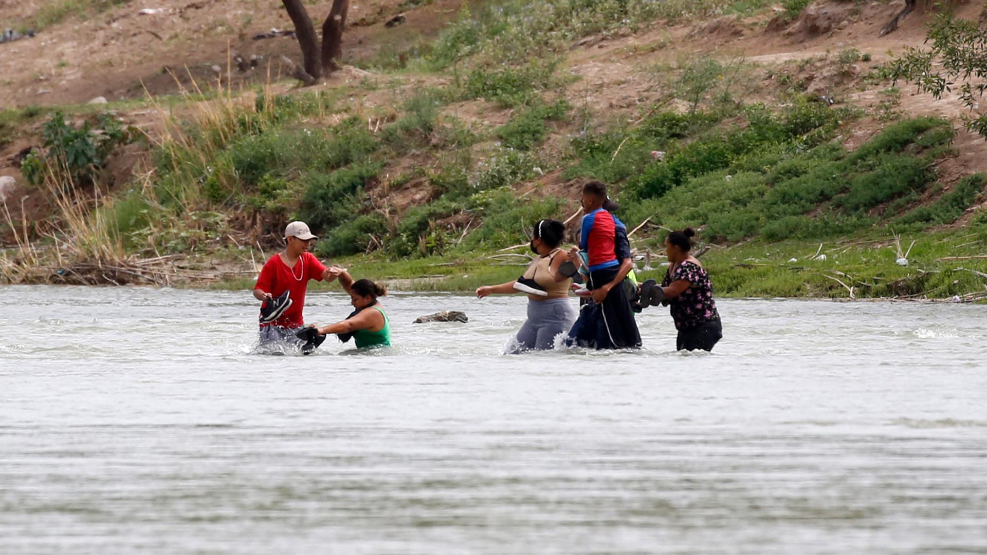 Migrants cross the Rio Grande river towards the US in Eagle Pass, Texas