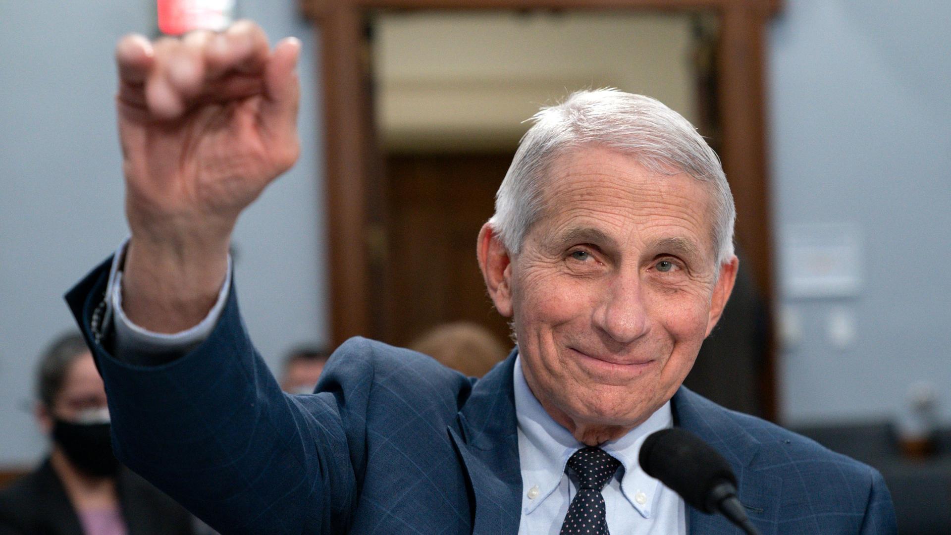 Dr. Anthony Fauci, director of the National Institute of Allergy and Infectious Diseases, waves hello to the committee at the start of a House Committee on Appropriations subcommittee on Labor, Health and Human Services, Education, and Related Agencies.